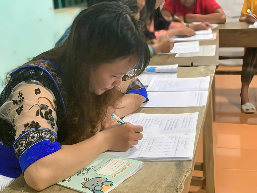 Các học viên lớp xóa mù tích cực rèn luyện viết chữ. lao-ty-phung-3.jpg